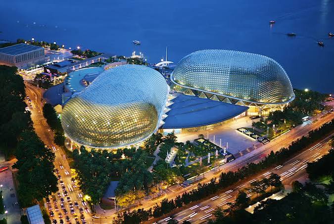 Esplanade Theatres on the Bay glowing gold at night on the waterfront