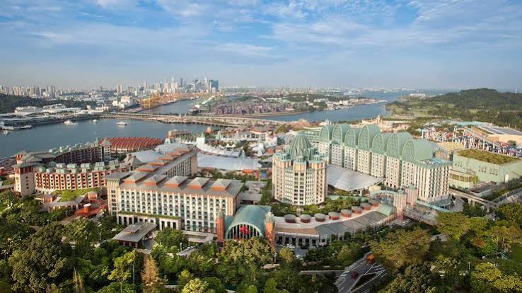 Aerial view of Resorts World Sentosa with Singapore’s skyline beyond the harbour